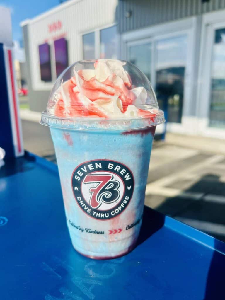 Blue raspberry milkshake with raspberry drizzle